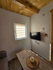 a living room with a table and a window at Cottage Martina in Žabljak