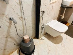 a bathroom with a shower and a toilet and a sink at Shree Gurukripa Inn in Maheshwar +17 photos