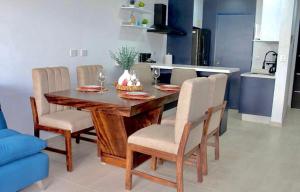 a dining room table and chairs in a kitchen at Almarena Mazatlan Departamento Nautico in Mazatlán +1 photo