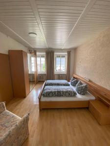 a large bedroom with a large bed and a couch at Moselurlaub im Ferienweinhaus Koch in Neumagen-Dhron