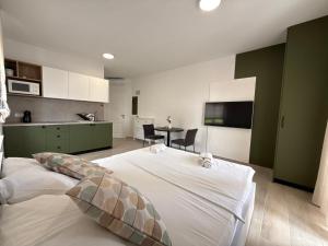 a bedroom with a large bed and a table at Apartments by Resort Čulina in Metajna