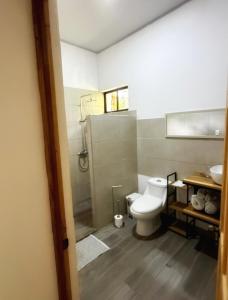 a bathroom with a toilet and a sink at Serenity House in Cahuita