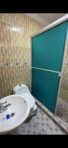 a bathroom with a toilet and a sink at Lohana's House Beach in Cartagena de Indias