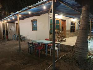 a table and chairs in front of a house at Lohana's House Beach in Cartagena de Indias