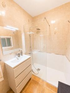 a bathroom with a shower and a sink and a tub at Casa do Carballo in Nigrán +14 photos