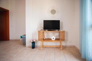a tv sitting on a table in a room at Mediterranea Modica - Seaside Home in Marina di Modica