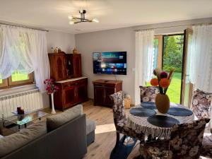 a living room with a couch and a table at Leśny Reset in Imielnia