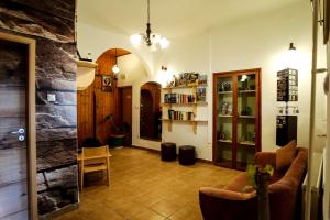 a living room with a couch and chairs in a room at Eged Panzió Eger in Eger
