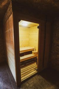 a wooden sauna with a bench in a room at Eged Panzió Eger in Eger