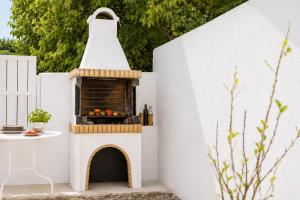 a pretend play house with a pizza oven at Villa Mytikas in Gennadi