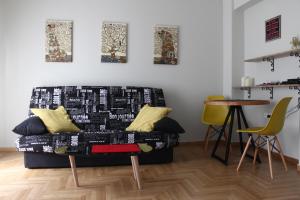 a living room with a couch and a table at Cheery Apartment in the Center of Athens in Athens