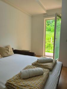 a bedroom with a large bed with two pillows on it at Apartments Vlavcheski in Peštani