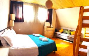 a bedroom with a bed and a bunk bed at Cozy Corner in Borjomi