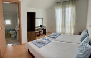 a hotel room with two beds and a bathroom at Apartments Vlavcheski in Peštani +17 photos