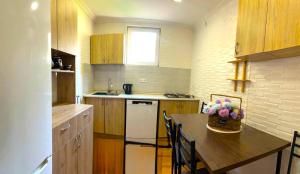 a kitchen with a table and a white refrigerator at Cozy Corner in Borjomi