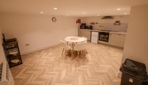 a kitchen with a table and chairs in a room at Rye Hideaway with Hot Tub - Rye in Rye