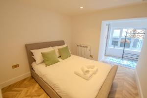 a bedroom with a bed with two towels on it at Rye Hideaway with Hot Tub - Rye in Rye
