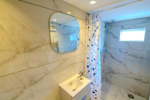 a bathroom with a sink and a mirror at Rye Hideaway with Hot Tub - Rye in Rye +12 photos
