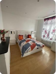 a bedroom with a bed and a desk and windows at Grace Family Home 2 in Brussels