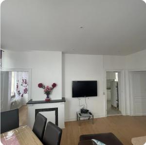 a living room with a fireplace and a flat screen tv at Grace Family Home 2 in Brussels