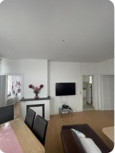 a living room with a table and a fireplace at Grace Family Home 2 in Brussels