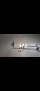 a pair of metal tongs with a blue object on it at Fo1 Apartment in Karsana