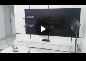 a room with a tv and a cat on a toilet at Fo1 Apartment in Karsana