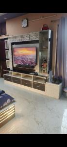 a flat screen tv sitting on a entertainment center at Countrysidecharm in Gwalior