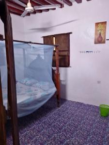a bedroom with a bunk bed in a room at Beiytul Noor Apartment in Lamu +3 photos