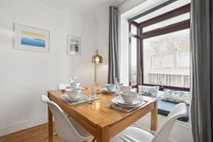 a dining room with a wooden table and chairs at 2 Bed in Swanage oc-wy547 in Swanage