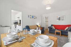 a living room with a table and a blue couch at 2 Bed in Swanage oc-wy547 in Swanage +14 photos