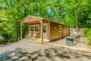 a small shed with chairs and a table in a yard at Serenity at the Smokies in Sevierville