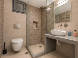 a bathroom with a toilet and a sink and a shower at Selena Villa in Kamari +101 photos