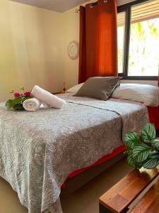 a bedroom with a large bed with a window at Fare Te Vaite in Tikehau Airport