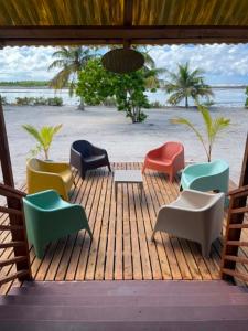 a group of chairs sitting on top of a wooden deck at Fare Te Vaite in Tikehau Airport