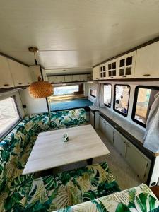 an interior of an rv with a table and couches at Przyczepa Wendy in Jastarnia