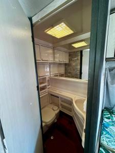 an inside view of an rv with a toilet and a tub at Przyczepa Wendy in Jastarnia +4 photos