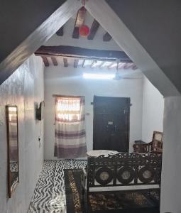 a bedroom with two beds in a room with a window at Beiytul Noor Apartment in Lamu