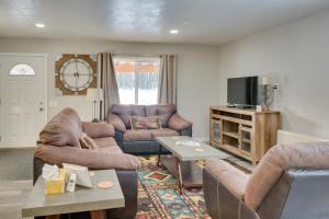 a living room with two couches and a tv at Kenai River Base! Spacious 2-Unit Cabin Compound in Soldotna