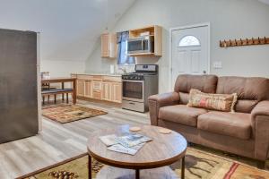 a living room with a couch and a table at Kenai River Base! Spacious 2-Unit Cabin Compound in Soldotna