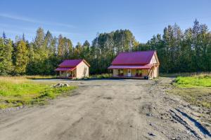 two houses with red roofs on a dirt road at Kenai River Base! Spacious 2-Unit Cabin Compound in Soldotna