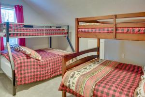 two bunk beds in a small room with at Kenai River Base! Spacious 2-Unit Cabin Compound in Soldotna