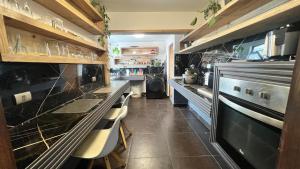 a kitchen with a counter and some chairs in it at House 78 in Coquimbo