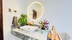a bathroom with a sink and a mirror on the wall at House 78 in Coquimbo
