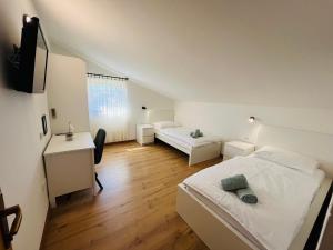 a bedroom with a bed and a couch and a desk at B&B Šegulja in Malinska