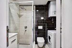 a bathroom with a toilet and a shower at Regency Aparthotel Sarajevo in Sarajevo +42 photos