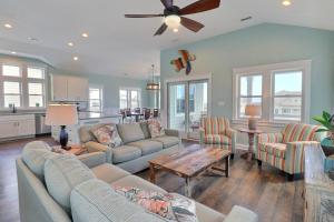 a living room with two couches and a table at 4058 - Beach Haven in Kitty Hawk