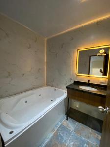 a bathroom with a bath tub and a sink at Hotel Colonial Sol y Luna in Paz de Ariporo +20 photos