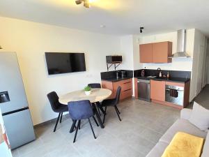 a kitchen with a table and chairs in a room at L'appartement de Maya in Saint-Priest