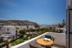 a balcony with a table and a view of the city at Yiannaki Hotel in Ornos